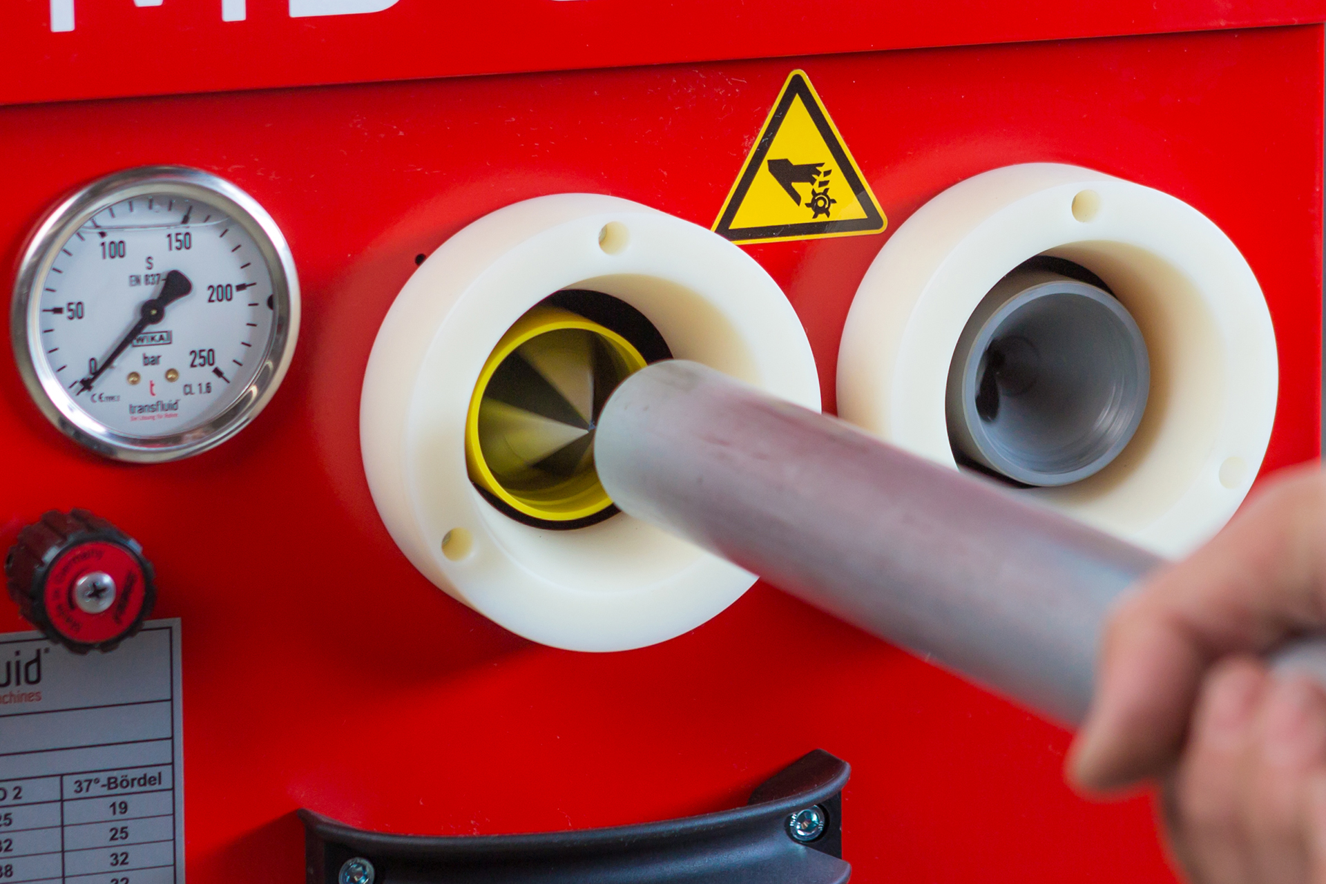 Entgraten eines Metallrohrs an CNC-Rohrbearbeitungsmaschine mit Innenwerkzeug und Druckanzeige.